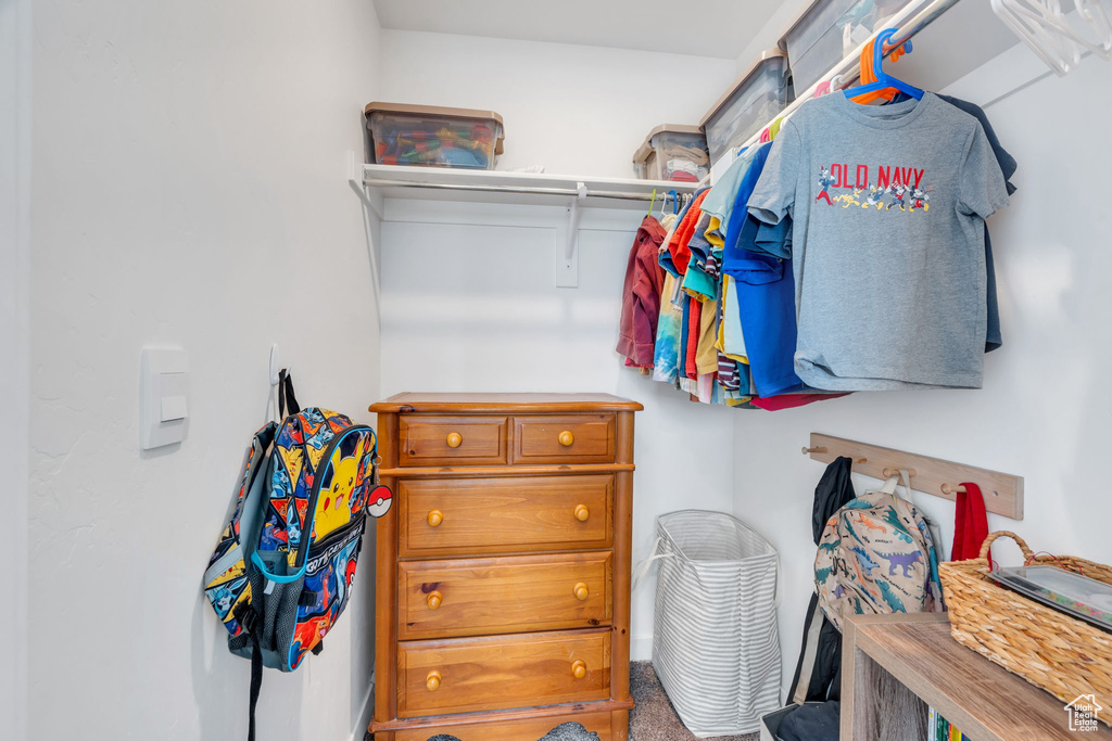 Walk in closet featuring carpet flooring