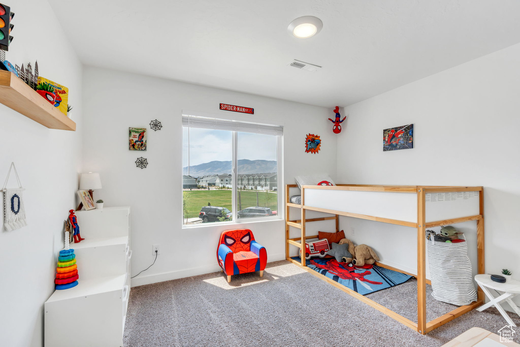 Carpeted bedroom featuring a mountain view and baseboards