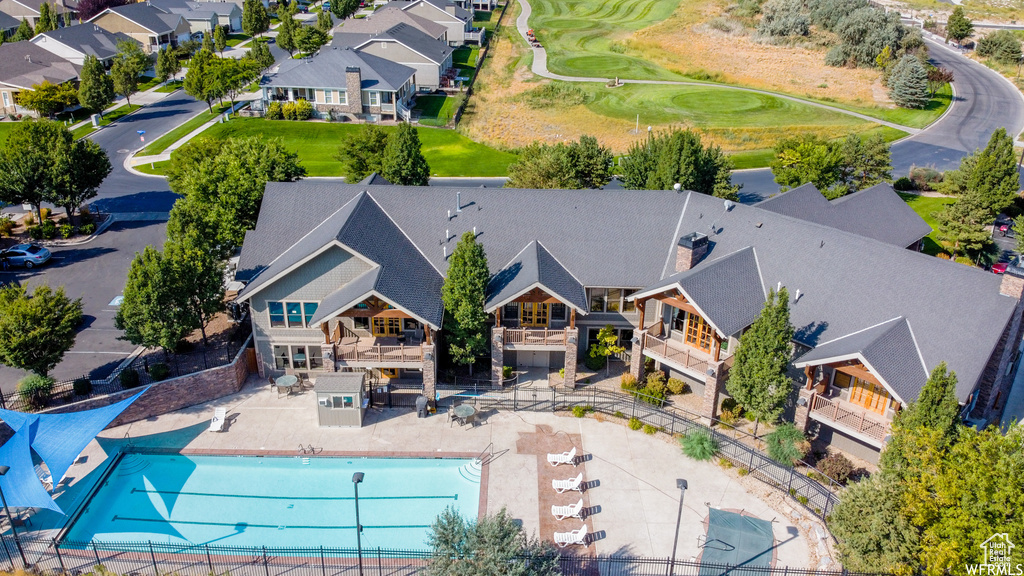 Aerial view of residential area featuring a pool area and a golf club