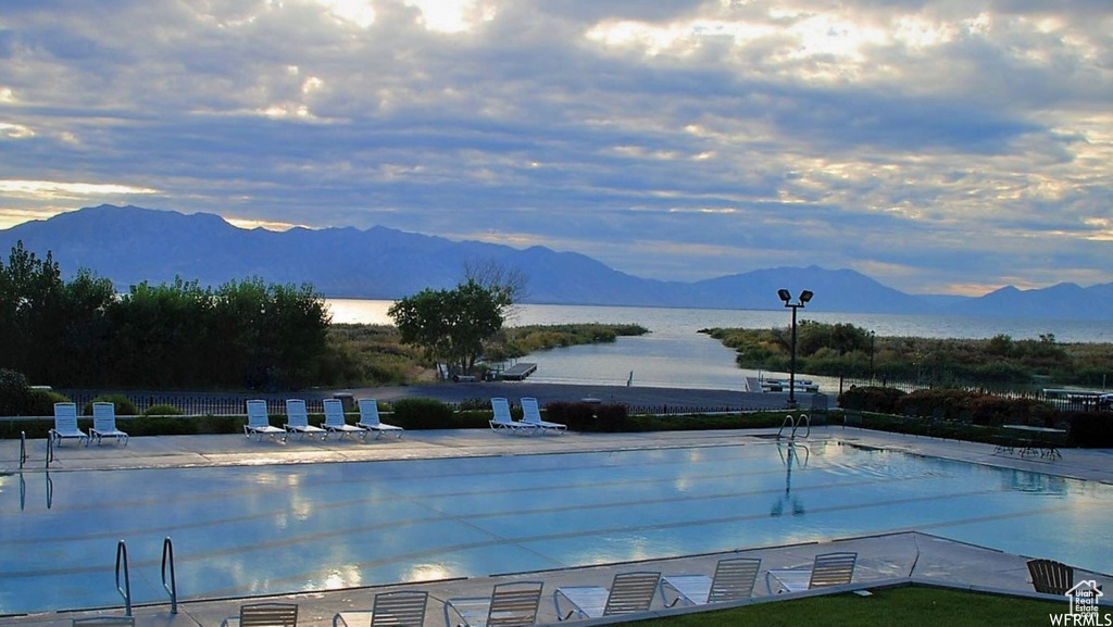 Community pool with a patio and a water and mountain view