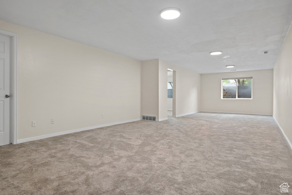 Empty room with carpet flooring and baseboards
