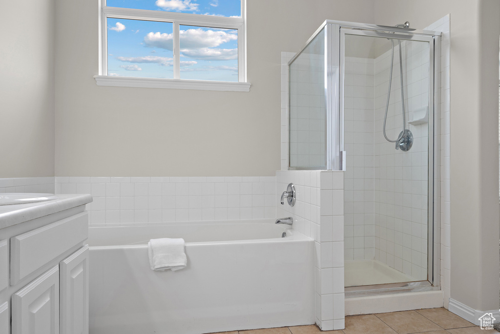 Full bath with a bath, tile patterned floors, a shower stall, and vanity