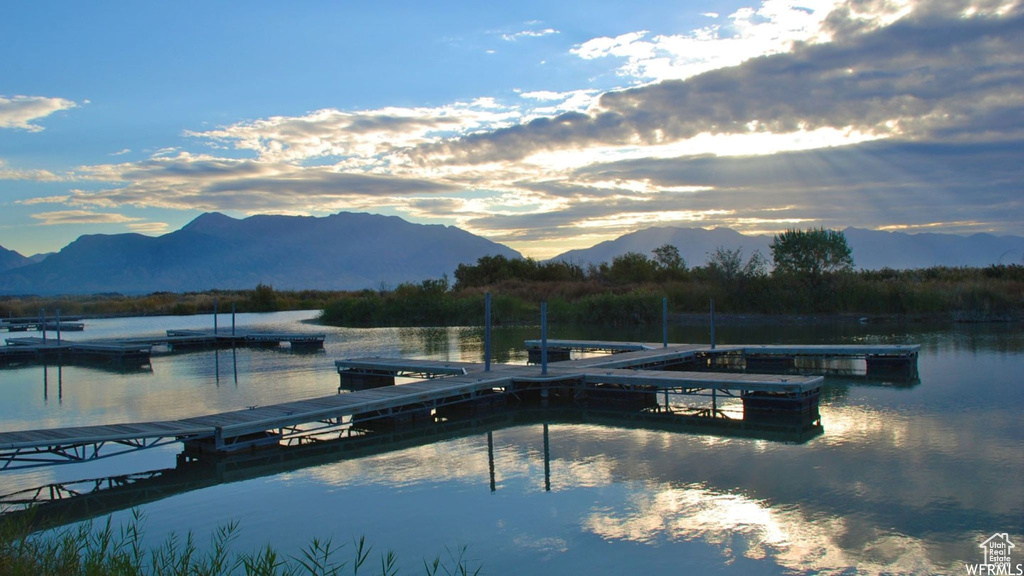 Dock area with a water and mountain view