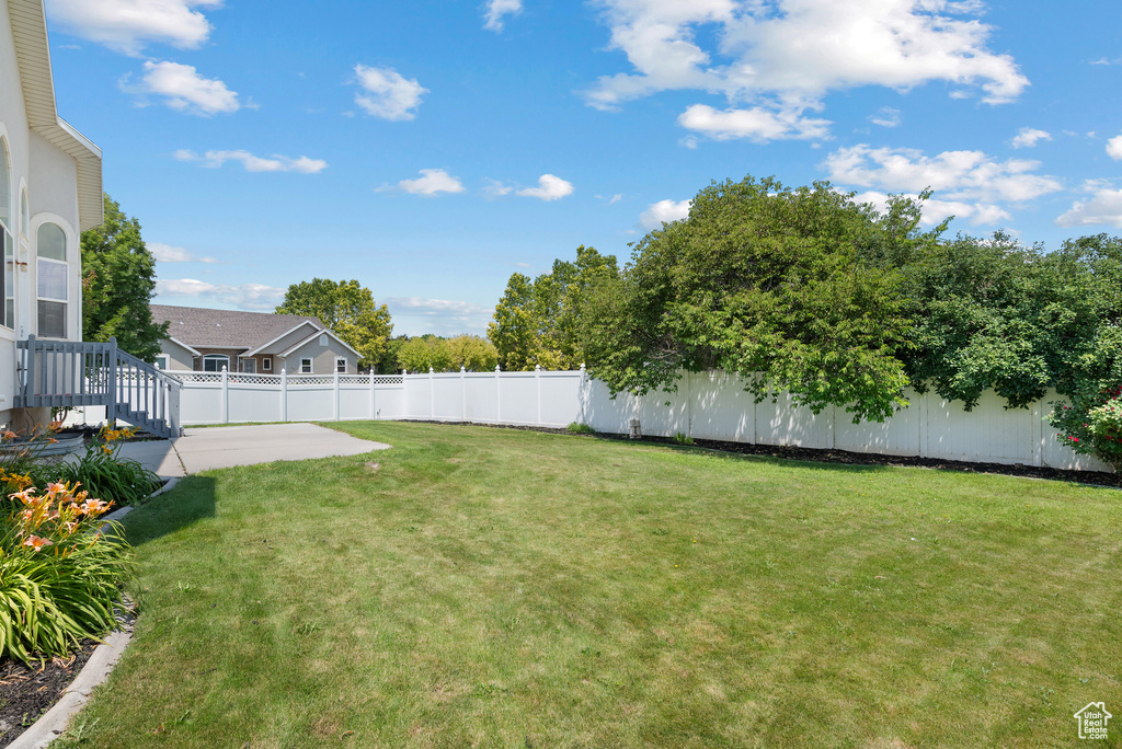 Fenced backyard with a patio area