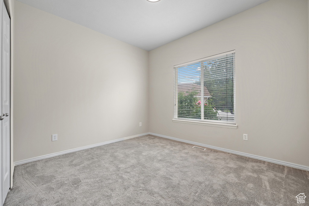 Spare room with carpet and baseboards