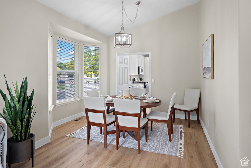 Dining area featuring a chandelier and light wood-style floors