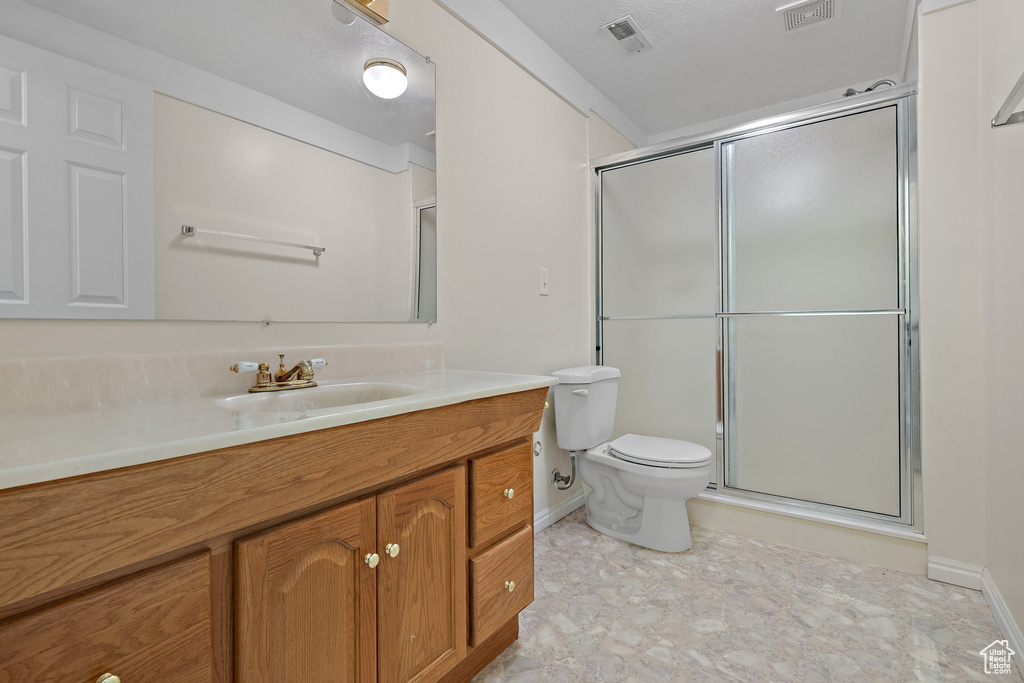 Full bath featuring vanity and a shower with shower door