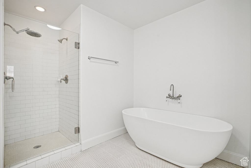 Full bathroom featuring a stall shower, a soaking tub, recessed lighting, and tile patterned floors