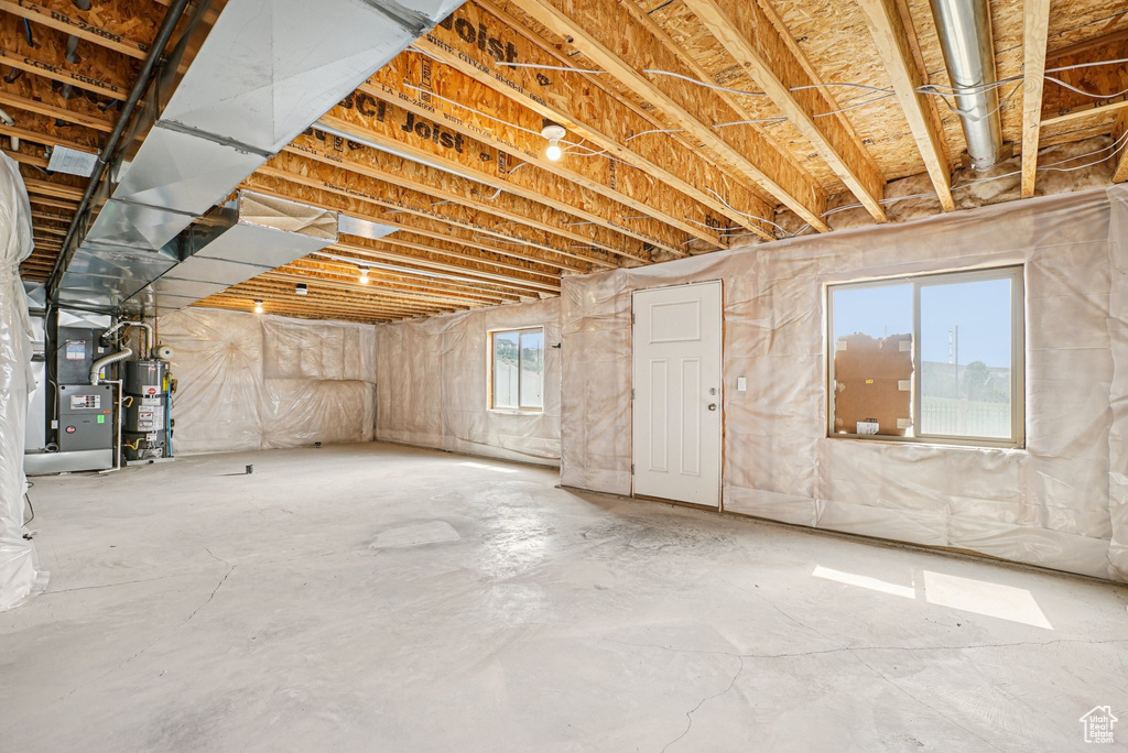 Below grade area featuring secured water heater and heating unit