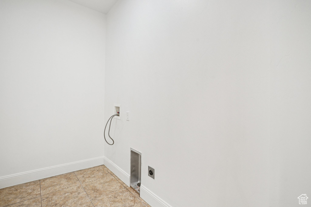 Laundry room featuring hookup for an electric dryer, washer hookup, and light tile patterned floors