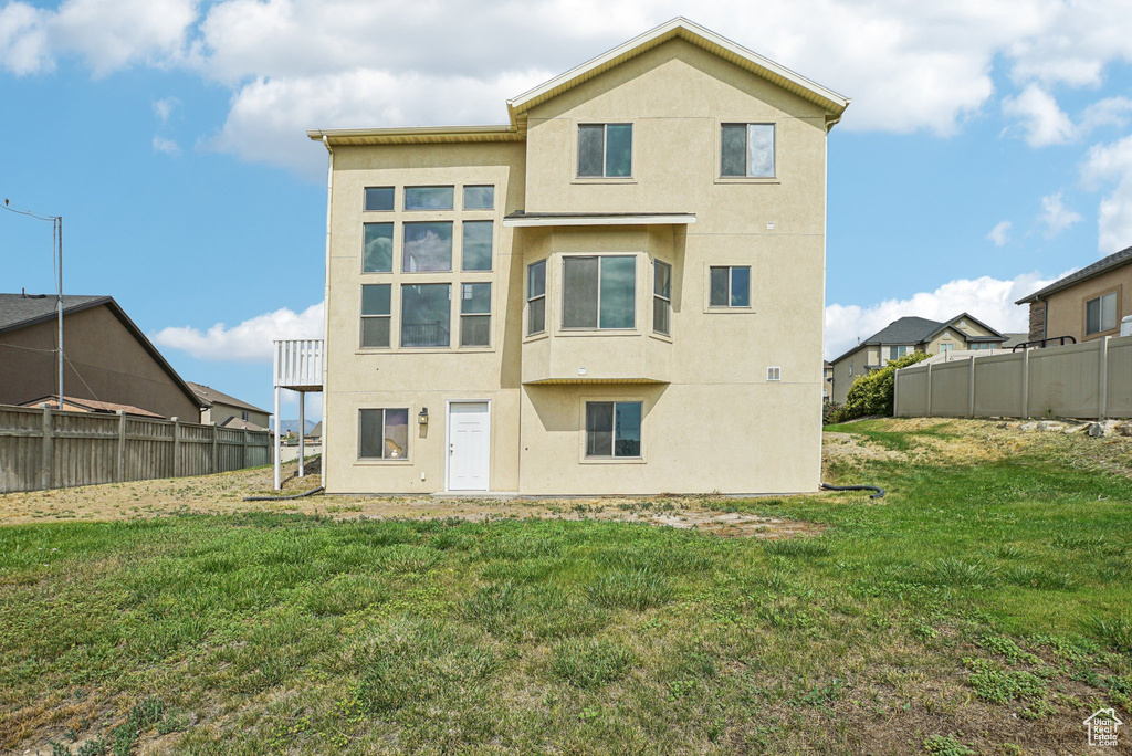 Rear view of property with stucco siding