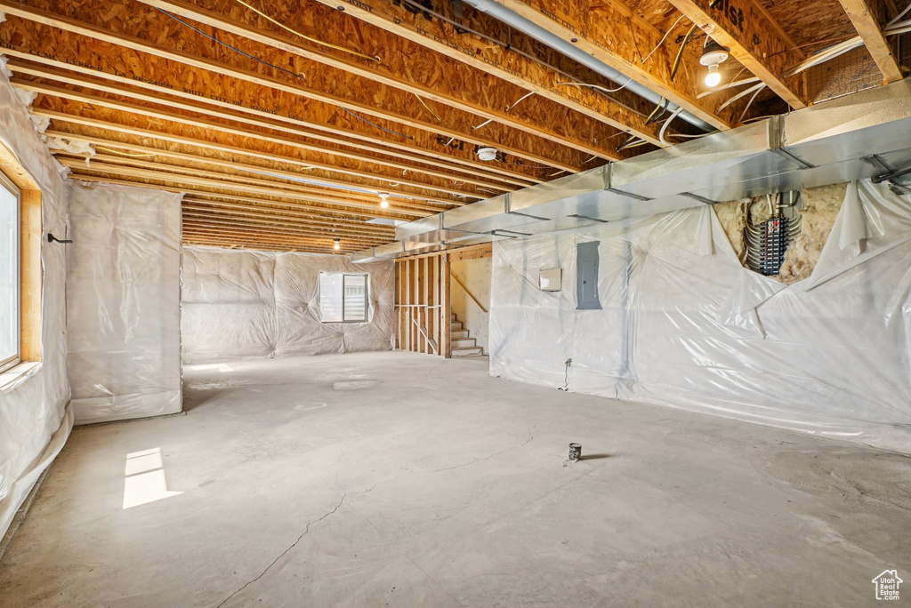 Basement with stairs and electric panel
