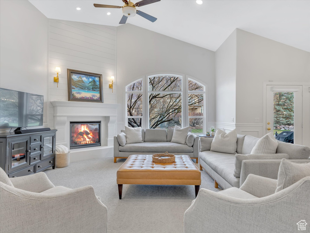 Living room with a ceiling fan, carpet flooring, recessed lighting, a large fireplace, and high vaulted ceiling