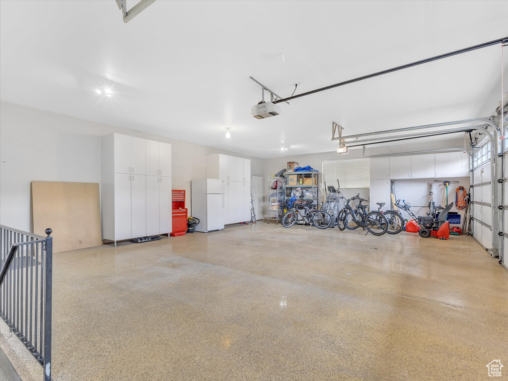 Garage featuring freestanding refrigerator
