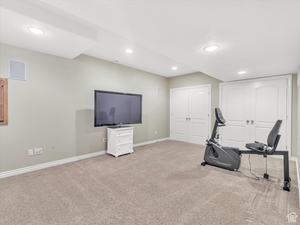 Workout room with carpet and recessed lighting
