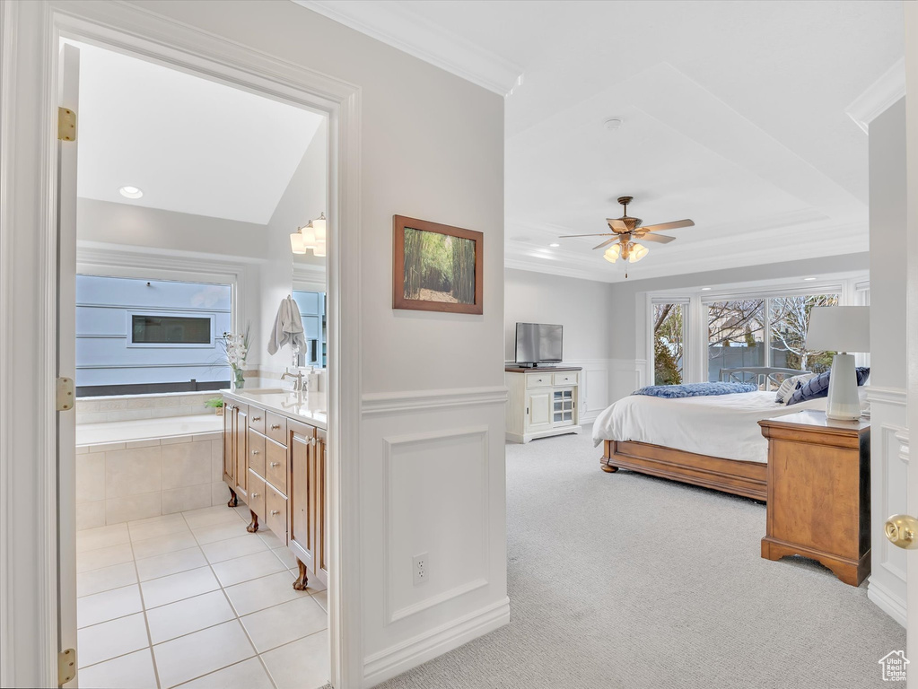 Bedroom with recessed lighting, ornamental molding, a decorative wall, ensuite bathroom, and a wainscoted wall