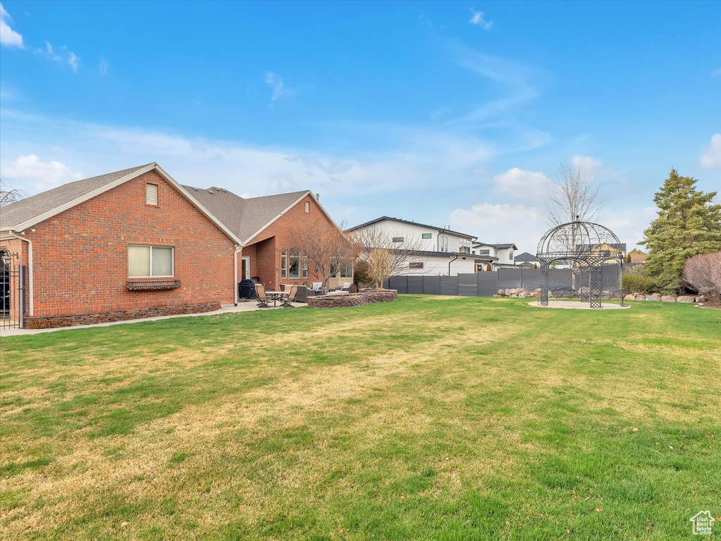 View of front of property featuring brick siding, an outdoor living space, and a patio