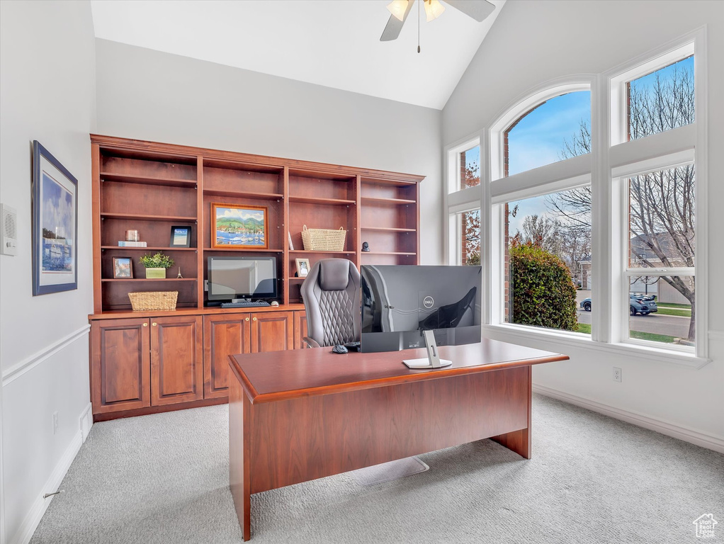 Office with light carpet, a ceiling fan, and high vaulted ceiling