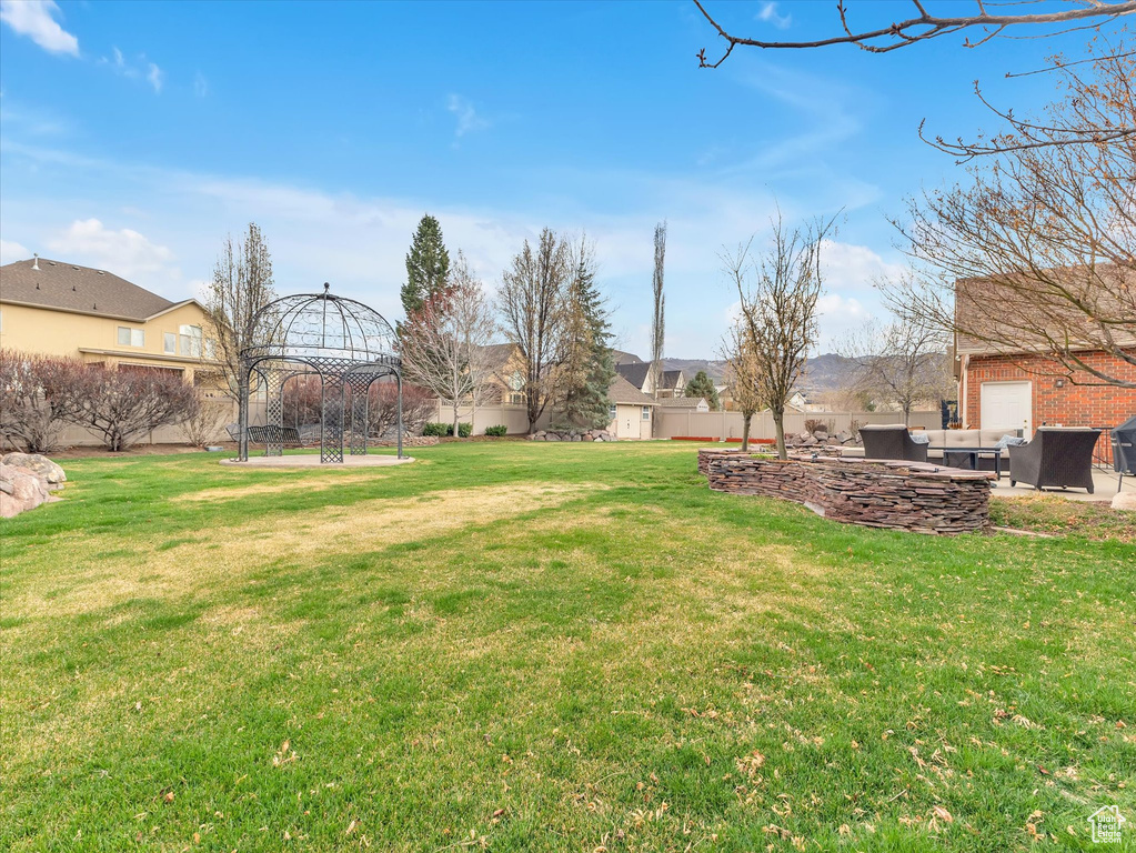 View of yard with an outdoor living space, a patio, and a residential view