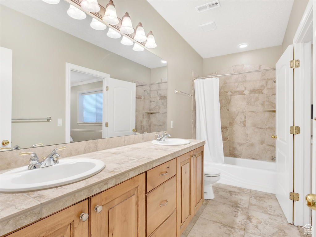 Full bathroom with double vanity and shower / bathtub combination with curtain