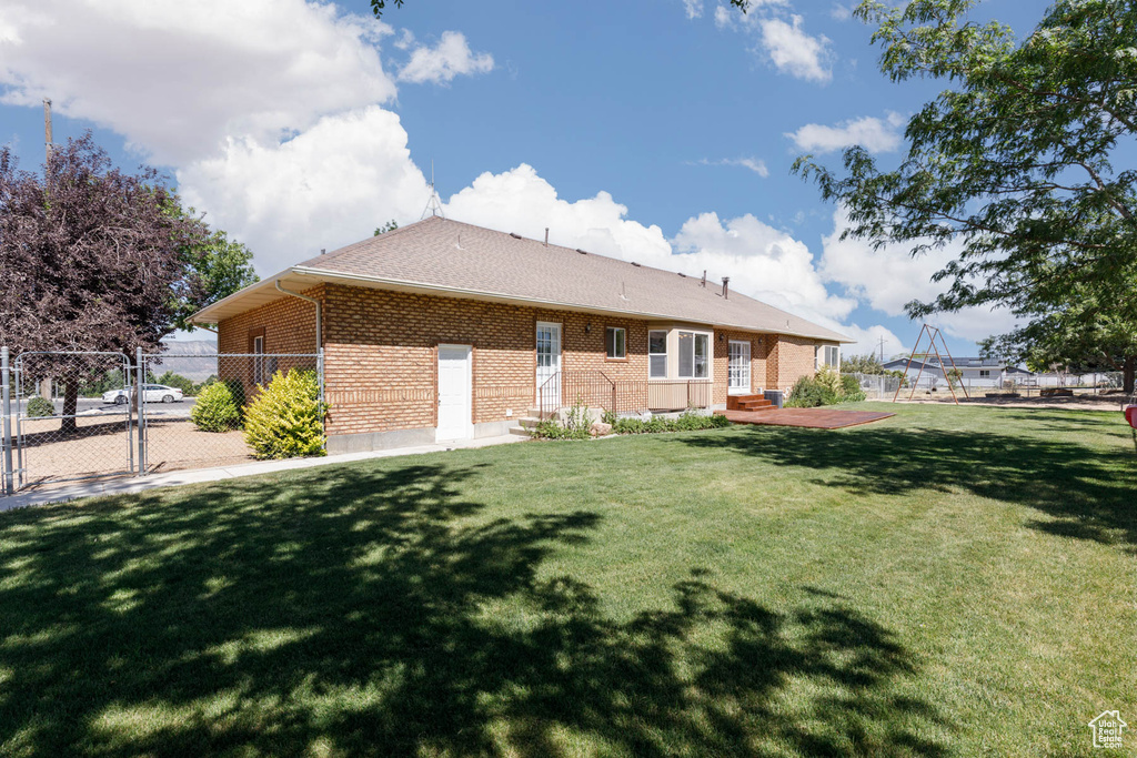 Rear view of house featuring brick siding