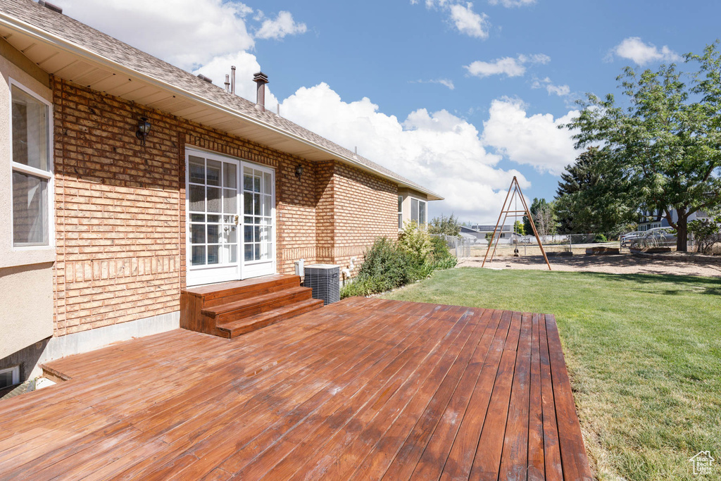 Wooden terrace with a lawn and french doors