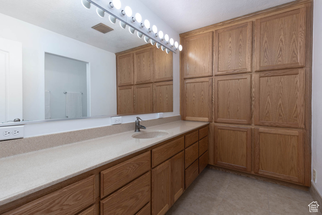 Bathroom featuring vanity and tile patterned flooring