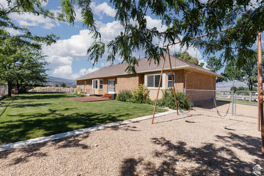 Rear view of property featuring brick siding