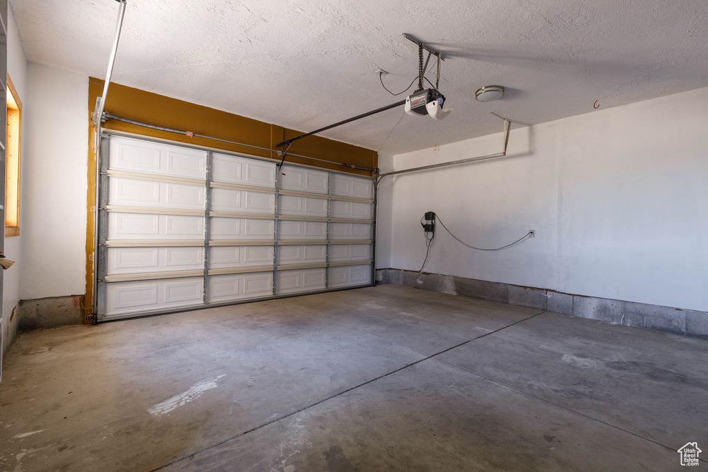 Garage featuring a garage door opener