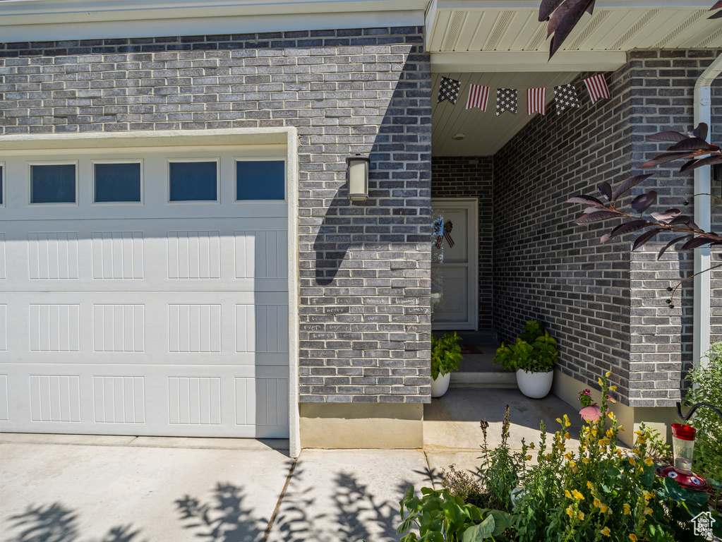 View of exterior entry featuring brick siding