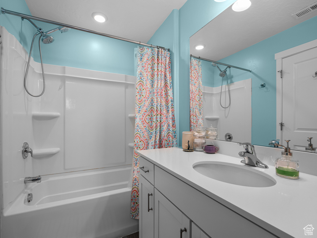 Full bathroom featuring shower / tub combo with curtain, vanity, and recessed lighting