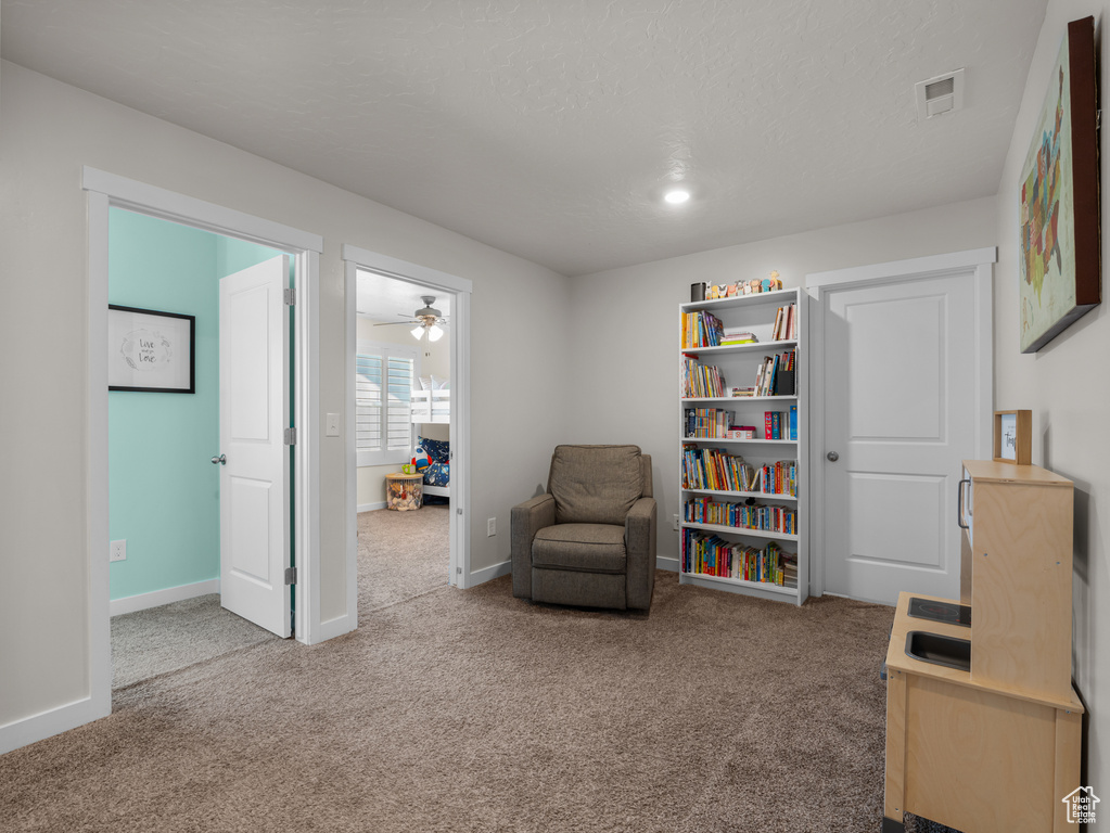 Living area featuring carpet floors and baseboards