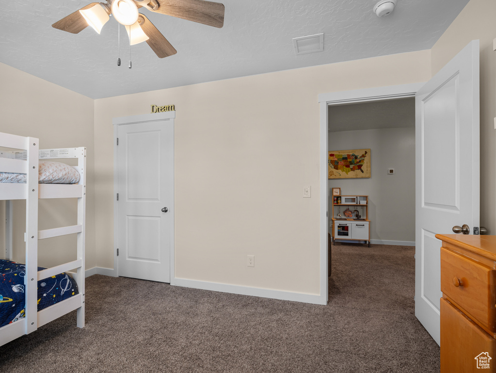 Bedroom featuring carpet floors and ceiling fan