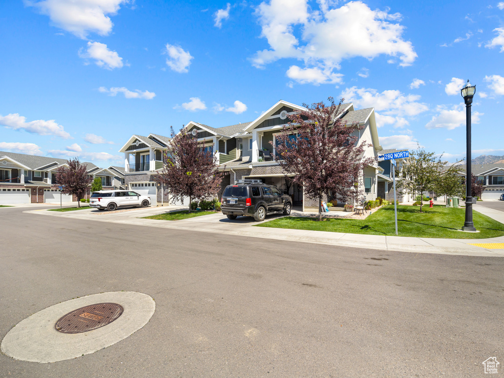 View of front of property with a residential view and driveway