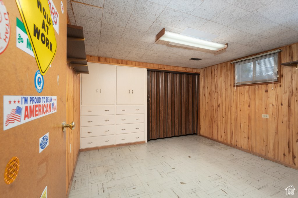 Finished below grade area with light flooring and wooden walls