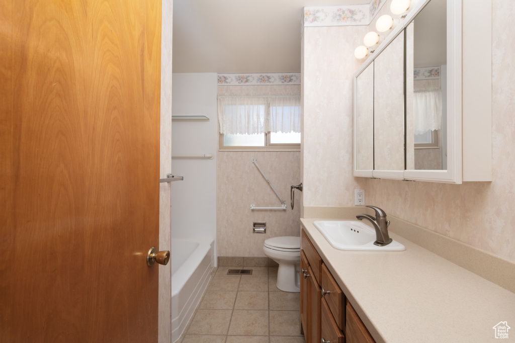 Bathroom featuring vanity, a bath, tile patterned flooring, and a shower