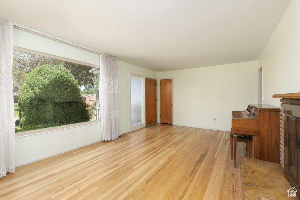 Unfurnished living room with wood finished floors and plenty of natural light