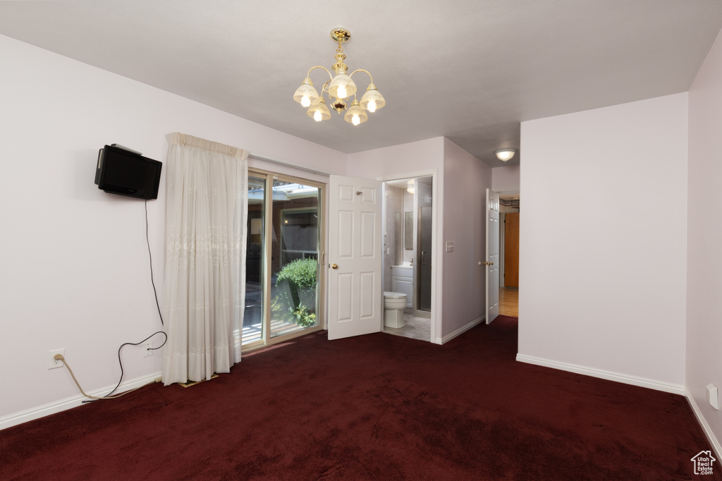 Unfurnished bedroom featuring carpet flooring, a chandelier, access to outside, and ensuite bathroom