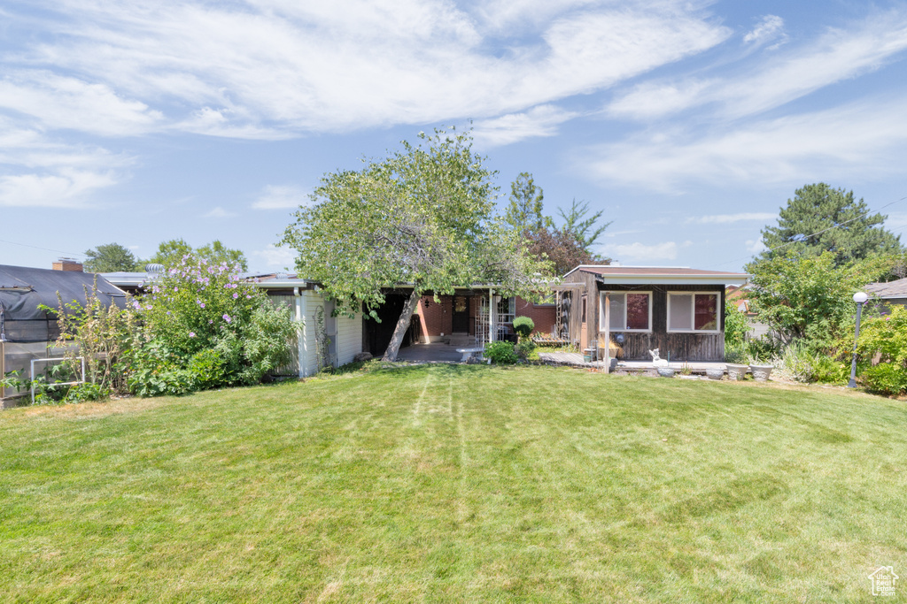 Rear view of house featuring a lawn