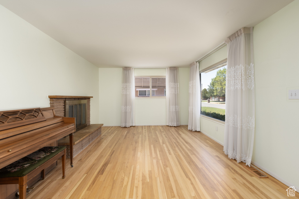 Living room featuring light wood-style floors and a fireplace