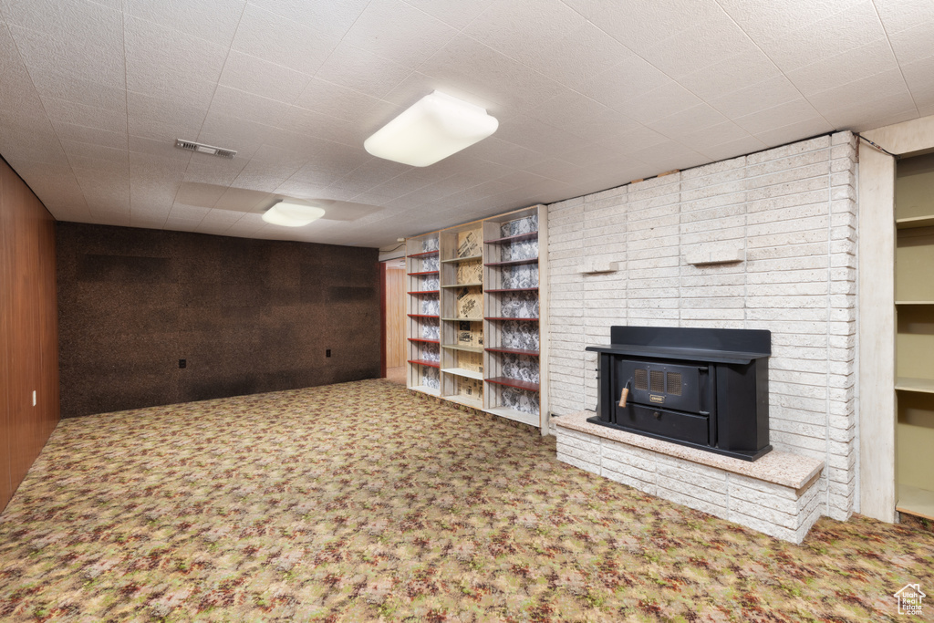 Finished below grade area featuring carpet and wooden walls