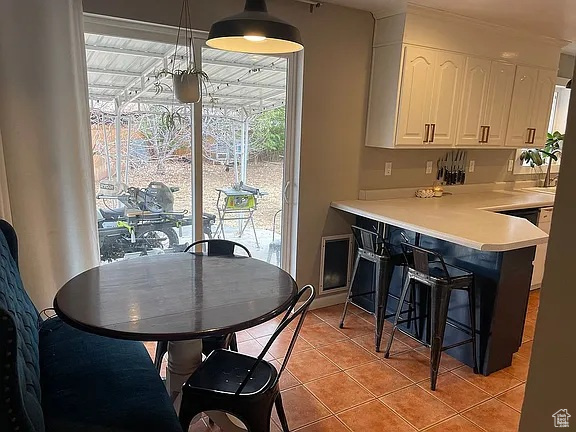 Dining room with light tile patterned floors