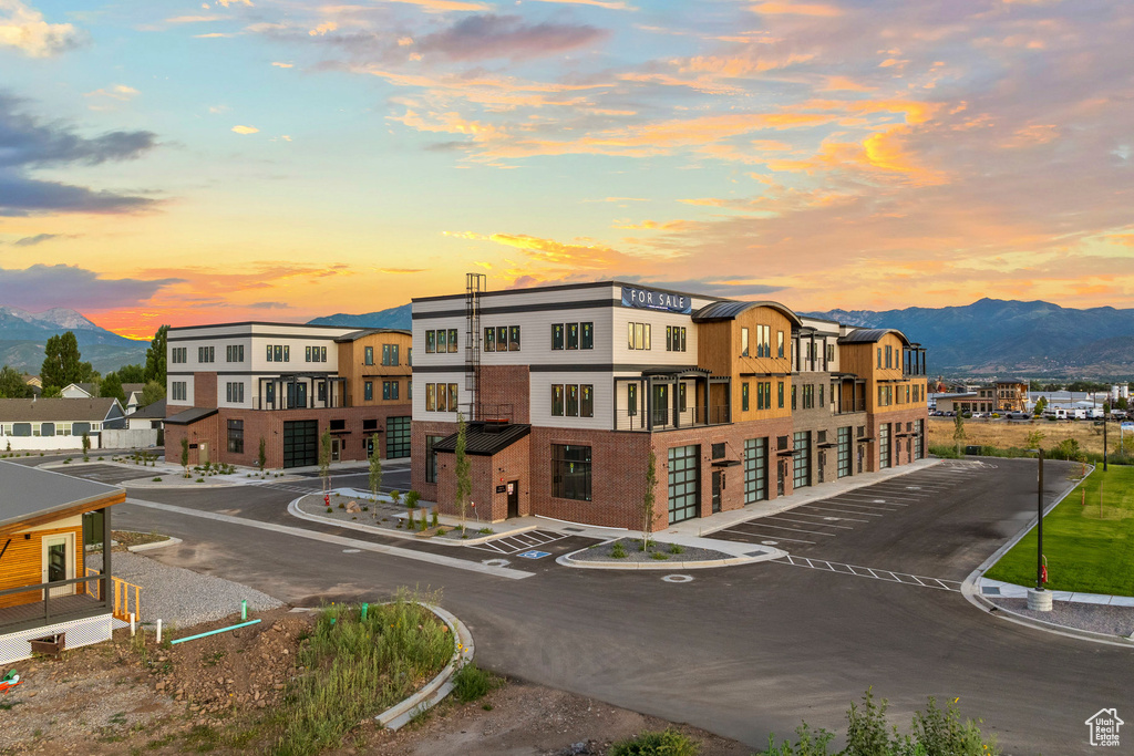 Property at dusk featuring a mountain view