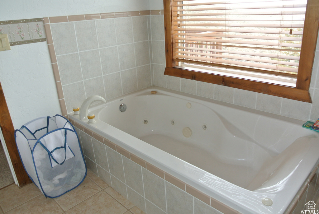 Full bathroom featuring a whirlpool tub and tile patterned floors