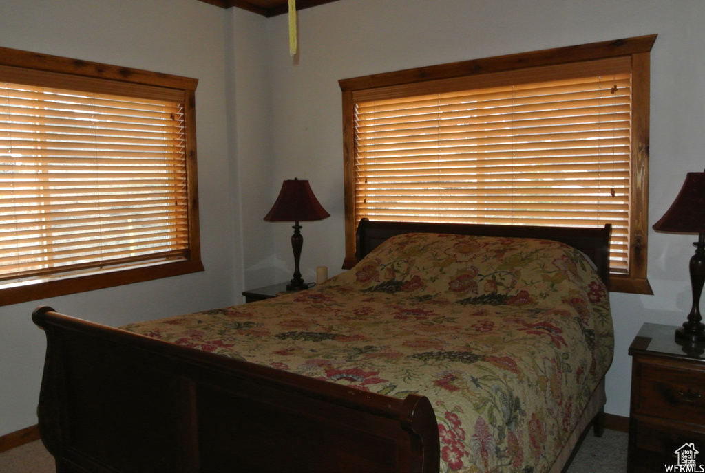 Carpeted bedroom featuring baseboards
