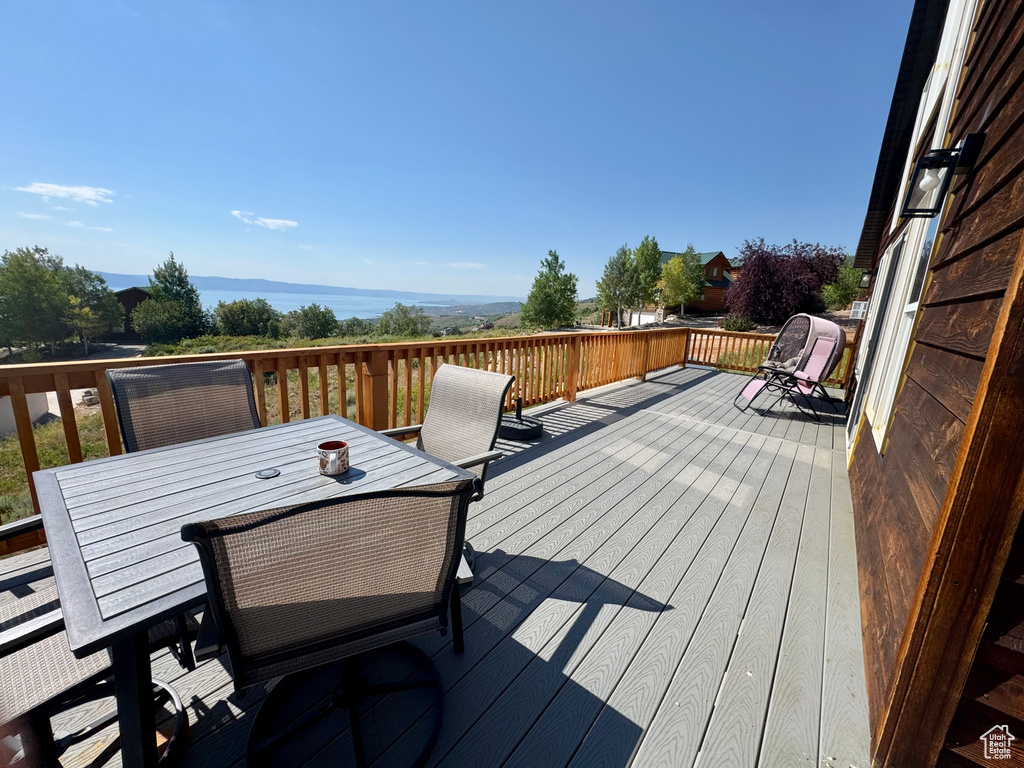 Wooden deck featuring outdoor dining area