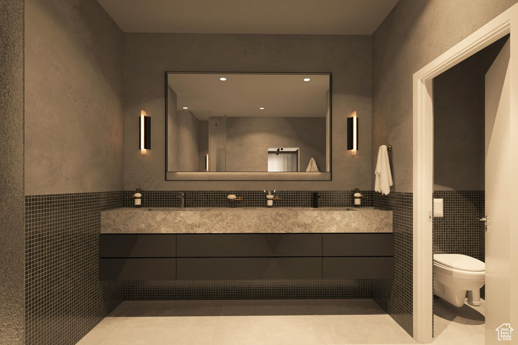 Bathroom with vanity, a wainscoted wall, and tile walls
