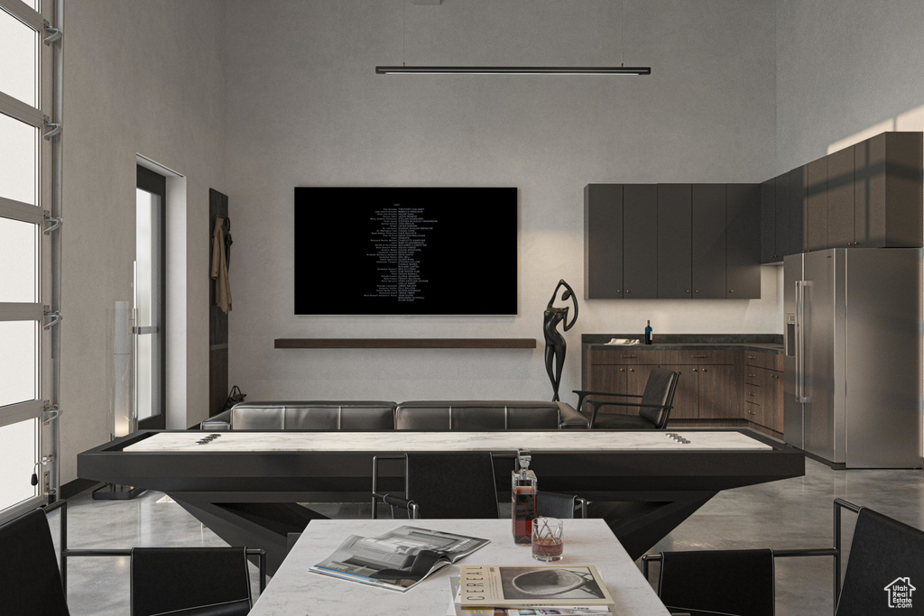 Kitchen with high end refrigerator and a towering ceiling
