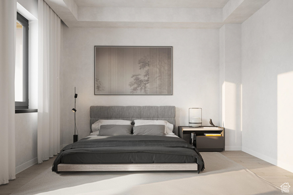 Bedroom with wood finished floors and baseboards