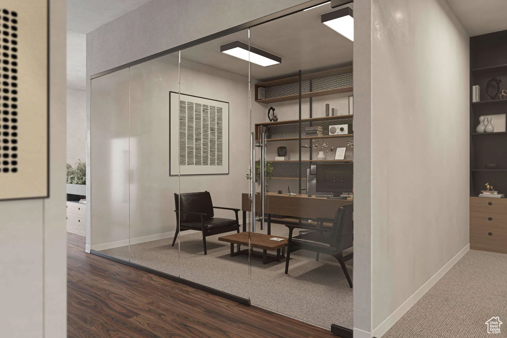 Sitting room featuring wood finished floors and an office area